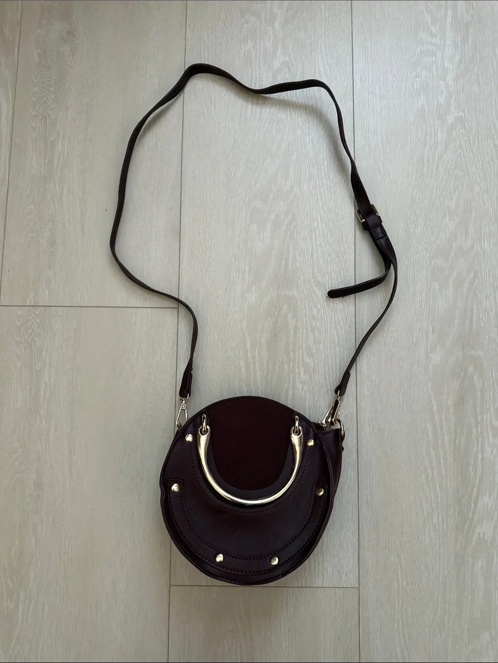 Round Crossbody Bag in Plum with Gold Accents